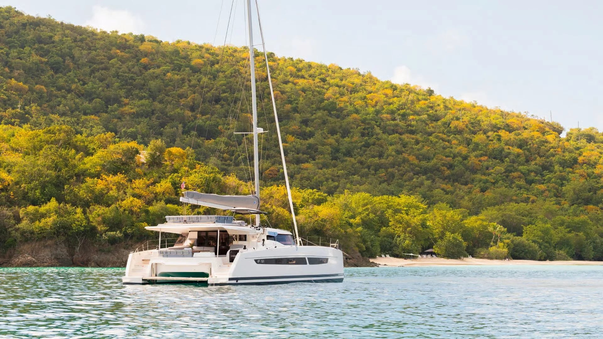 Aura 51 private luxury catamaran anchored near tropical island RivieraYachtExperience