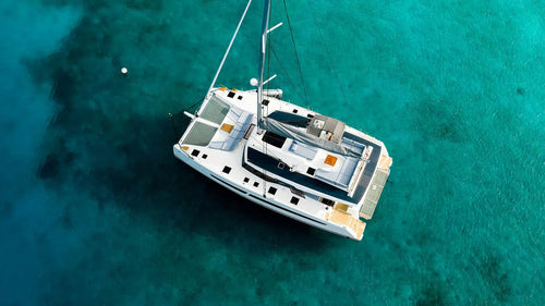 Aura 51 luxury yacht charter in crystal clear turquoise water RivieraYachtExperience